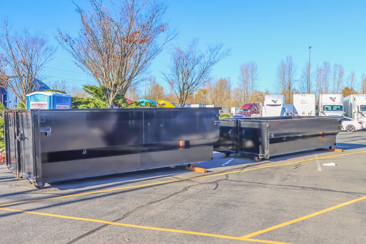 Professional dumpster rental service with roll-off container on residential driveway in Poughkeepsie